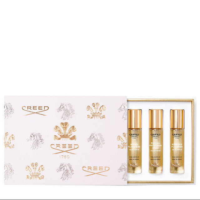 Creed perfume set showing three bottles in a decorative box on a white background