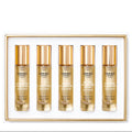 Set of five Creed perfume bottles in a gold frame on a white background